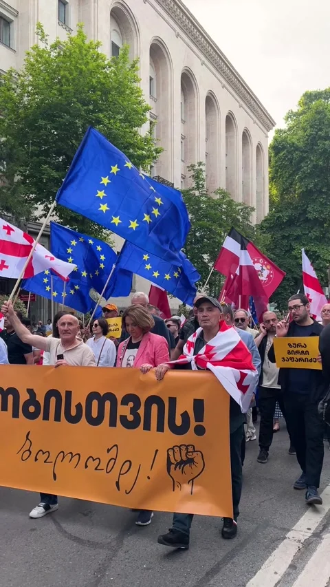 Vertical street 4K video. 60 fps. Crowd of people with yellow banner, EU flag Video stock 343683717