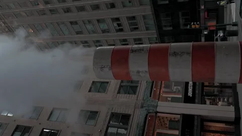 A vertical street view of one of an iconic orange-and-white striped stack in Stock Footage 342938342