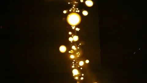 Vertical stripe yellow lanterns glowing amid the darkness. Garland light and swa Stock Footage 82751537