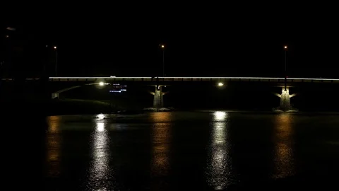 Vertical strips of light from the bridge lanterns on the small river. Stock-Footage 91096881