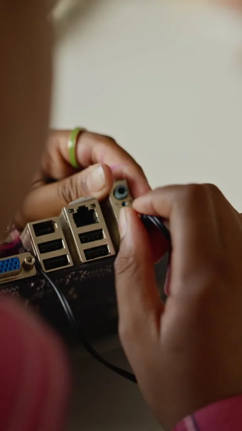 Vertical of Student Connecting Cable to Motherboard in Stem Class Stock Footage 340547058