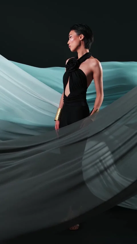 Vertical studio portrait of a young asian model in black jumpsuits and bright Stock Footage 269495947