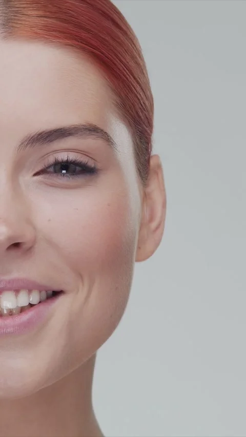 Vertical studio portrait of young, beautiful and natural redhead woman applying Stock Footage 279962473