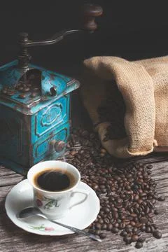 Vertical studio shot of still life with vintage manual green metal coffee Stock Photos