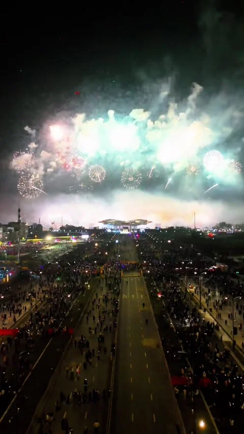 Vertical - Stunning Blue and White Fireworks Display Over Large Crowd Stock Footage 331760682