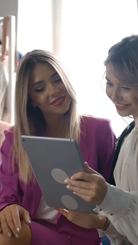Vertical of Stylish friends using tablet in shop. Stock Footage 276921966