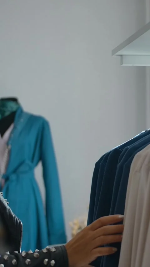 Vertical of Stylish lady choosing clothes in shop. Stock Footage 276928820