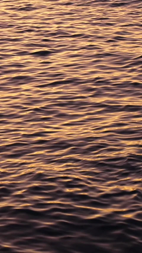 Vertical sun reflection on the blue water surface. Calm waves at sunset. Deep Stock Footage 292217331