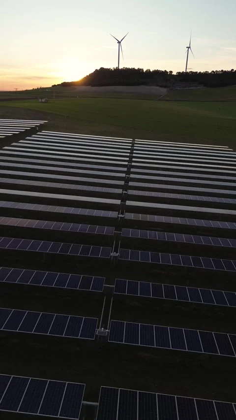 Vertical Sunset Drone Shot of Solar Panels with Wind Turbines Stock Footage 330051298