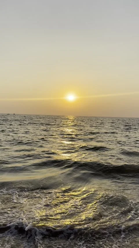 Vertical sunset ocean waves gently crashing on beach shore Goa India 動画素材 343156032