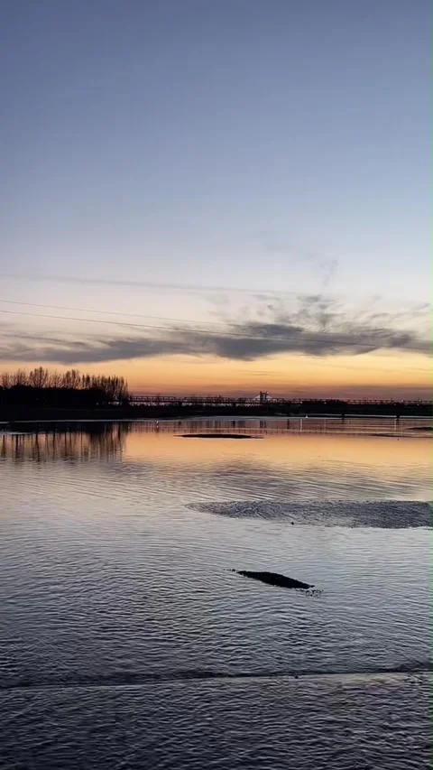 Vertical Sunset Over Calm River With Bridge Silhouette 스톡 동영상 334764777