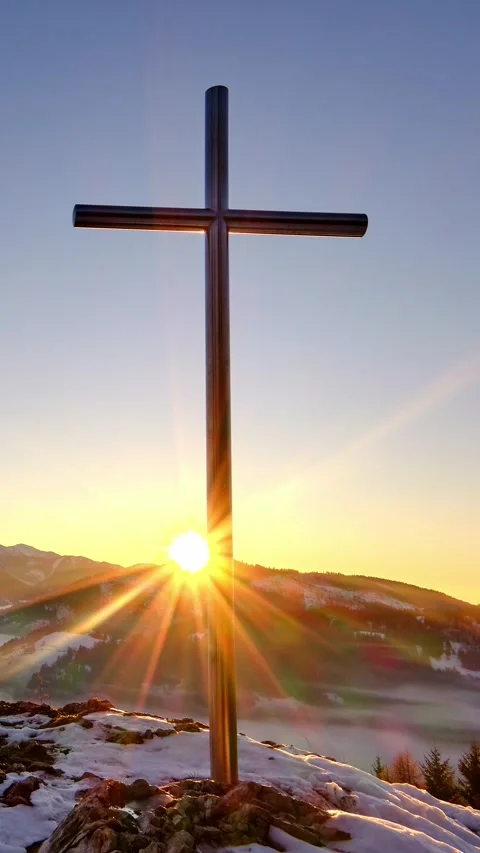 Vertical, Sunset over Christian cross in peaceful snowy and misty winter Stock Footage 294571504