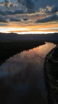 Vertical Sunset Over River with Mountain Silhouette in Attapeu, Laos Stock Photos