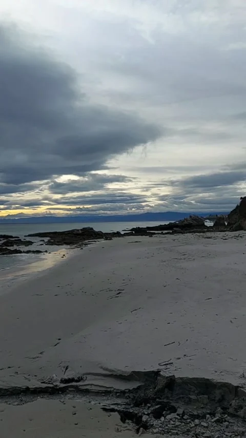 Vertical Sunset Over Sandy Beach with Dramatic Clouds Video stock 339512412