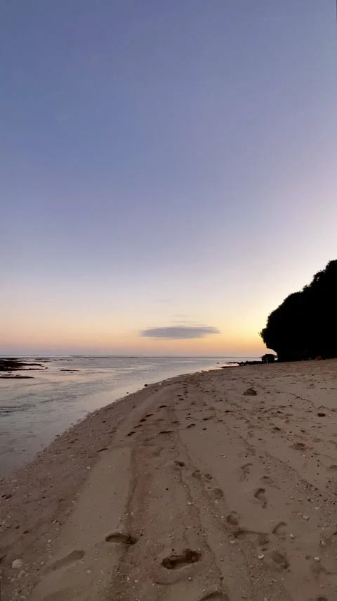 Vertical Sunset Sandy Beach with Footprints and Lonely Cloud Stock Footage 337354733