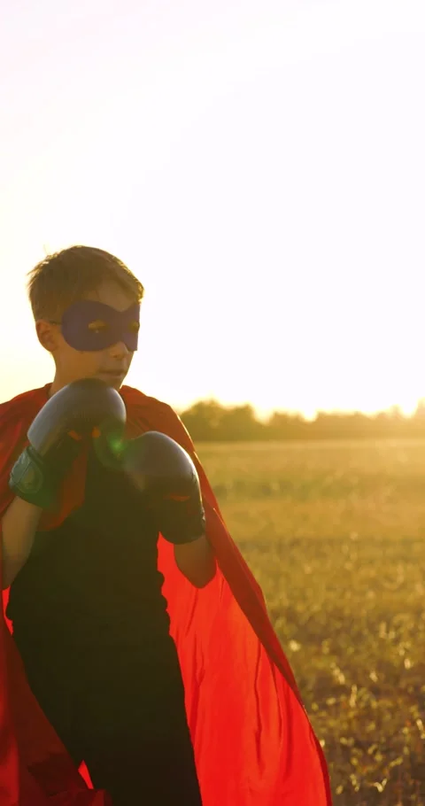 Vertical superhero boy stands ready. Mobile video of superhero boy stance. Kid Stock Footage 330008711