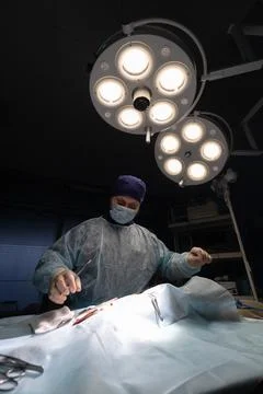 Vertical. A surgeon in the operating room during an operation on a patient. A Stock Photos