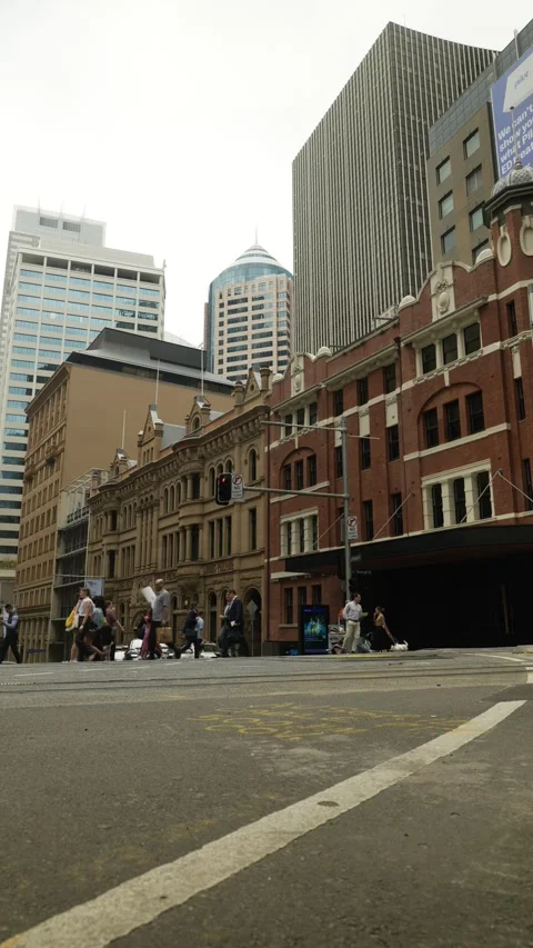 Vertical Sydney commutors cross the road in CBD 6K Stock Footage 306501864