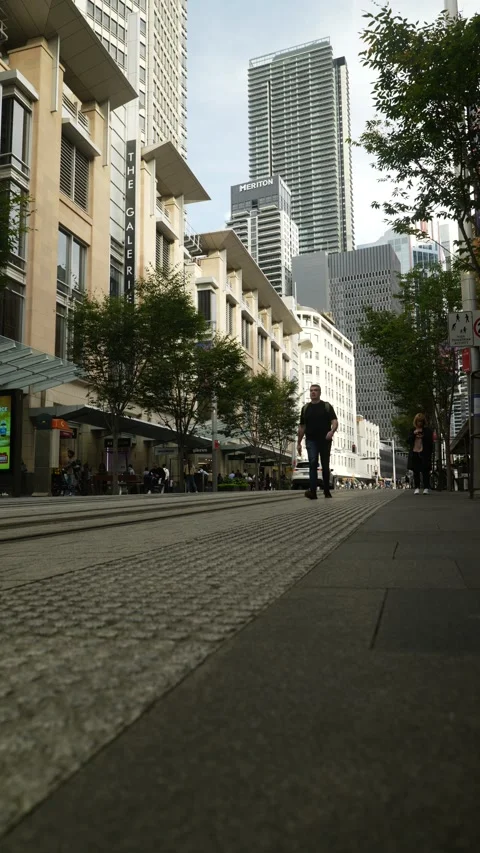 Vertical Sydney pedestrians cross tram line 6K Stock Footage 306564501