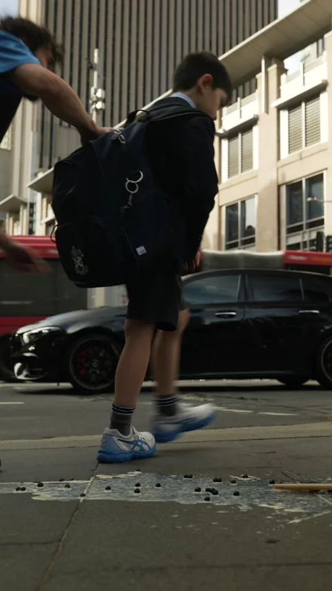 Vertical Sydney schoolboy next to traffic in the city 6K Stock-Footage 306518887