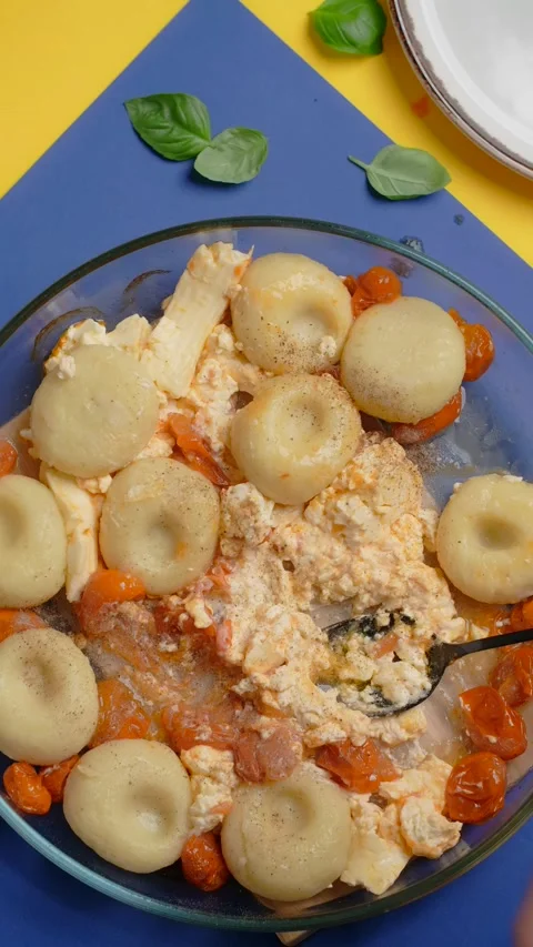 Vertical tabletop video: chef adds spices to the plate with potato dumpling with Stock Footage 179560595