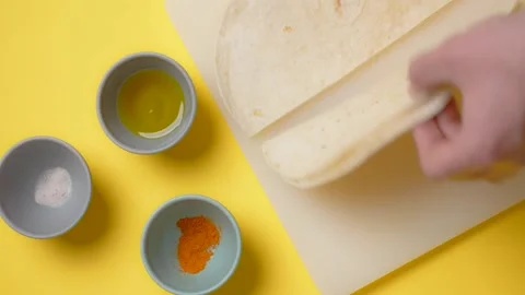 Vertical tabletop video: chef cookes mexican food, man slices corn tortilla to Stock Footage 180578921