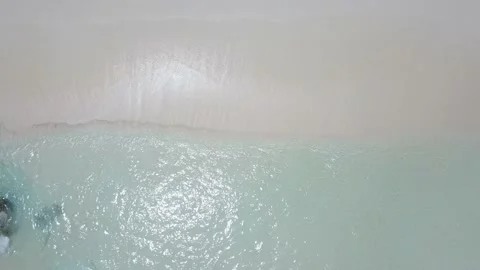 Vertical take drone shoot when waves wash white sand of beatuful tropic islands Stock Footage 120243169