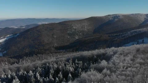 Vertical takeoff over winter forest in Beskids Mountains Stock Footage 144458285