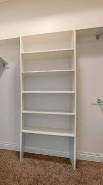 Vertical tall frame Interior of a walk in closet with shelves and shiny garment Foto stock