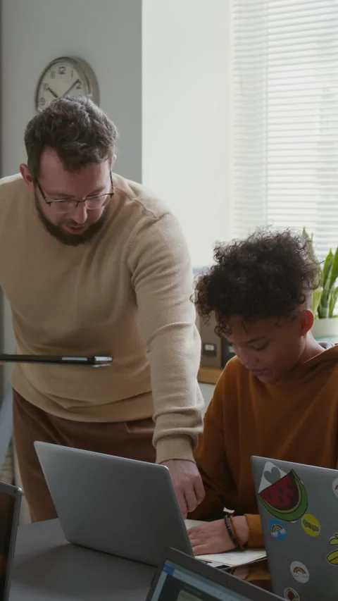 Vertical of Teacher Giving Advice to Boy Drawing Diagram at Coding Lesson Stock Footage 318728631
