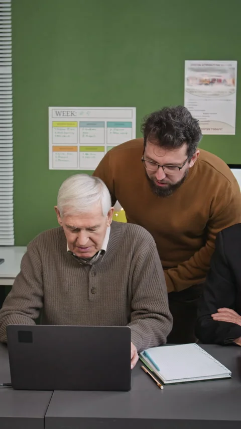 Vertical of Teacher Helping Senior Students in Computer Class Stock Footage 333708418
