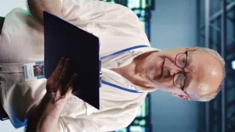 Vertical Technician crosschecking server parts Stock Footage 247929676