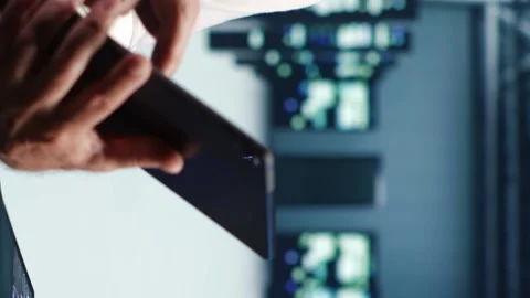 Vertical Technician running code in data center Stock Footage 248420974