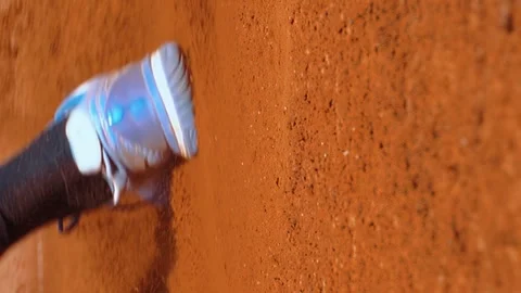 Vertical tennis player slides down running on sand court close up sliding Stock Footage 249476194