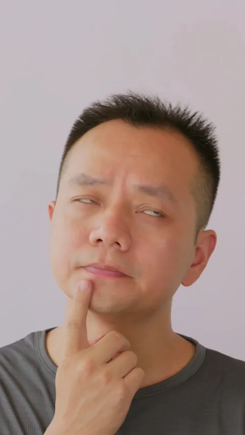 Vertical Thinking idea and Asian man in studio with question doubt Stock Footage 342471746