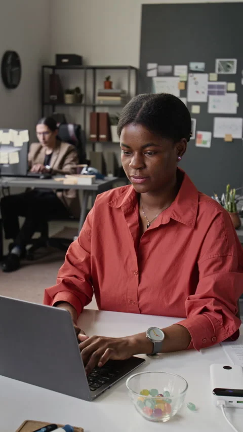 Vertical of Thoughtful Black Woman Programmer Working on Laptop in Office Stock-Footage 336716471