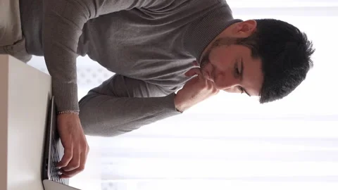 Vertical thoughtful developer remore man laptop Stock Footage 256122781
