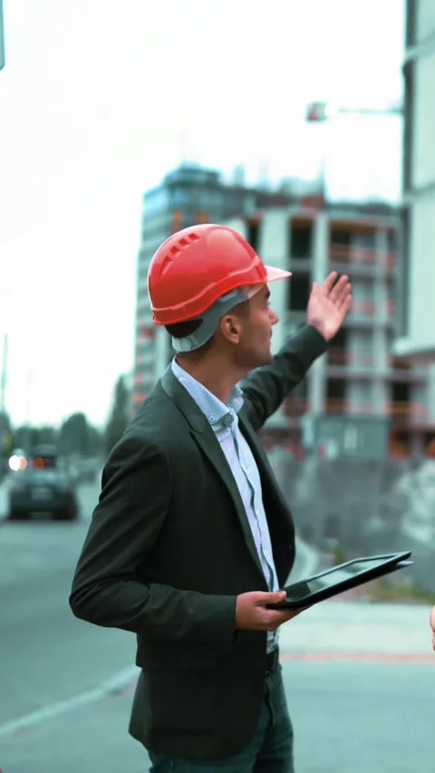 Vertical of Three architects discuss newly constructed building Stock Footage 305517827