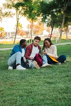 Vertical Three young students studying and doing homework on a university campus Stock Photos