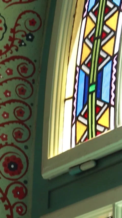 Vertical Tilt Down of Stained Glass Window and Decorative Wall Art Stock-Footage 330368505