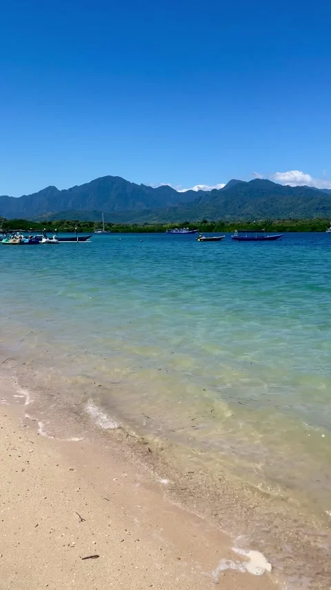 Vertical Tilt Up Turquoise Beach and Mountains Bali Stock Footage 335916117