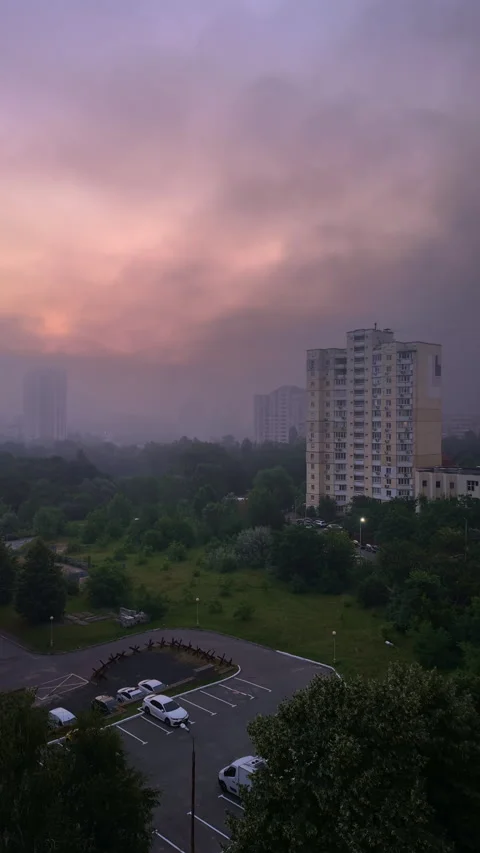 Vertical time-lapse of black smoke drifting over city at dawn after drone s.. Stock Footage 315210802