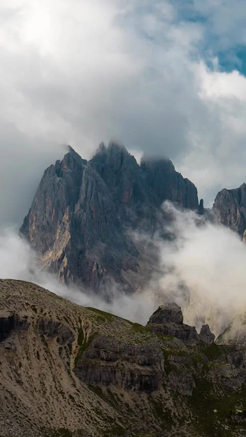 Vertical Time Lapse of Clouds Moving Around Peaks of Italian Dolomites Stockbeeldmateriaal 341842436