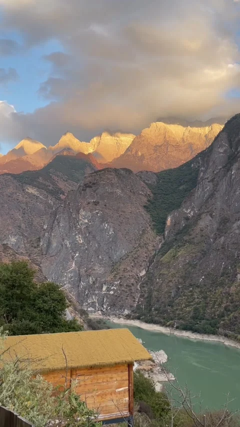 Vertical Time-lapse of Golden Sunlit Peaks and Moving Clouds over Tiger Leap Stock Footage 330145067