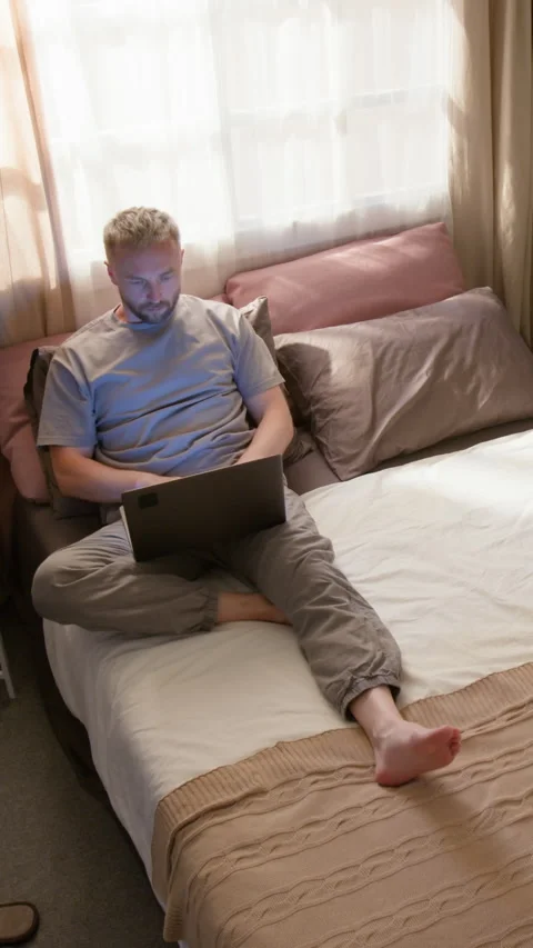 Vertical Time Lapse of Man Waking in Morning and Working on Laptop from Home Stock Footage 314840456