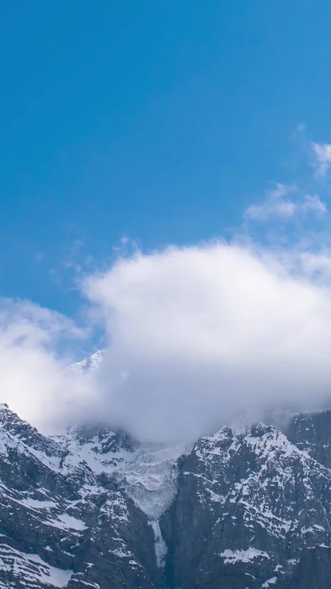 Vertical Time-lapse shot of clouds rolling above the snowy Himalayas Stock Footage 280060131