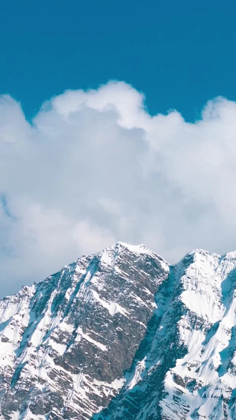 Vertical Time Lapse shot of clouds under the snow covered Himalayan mountain Stock Footage 281066245