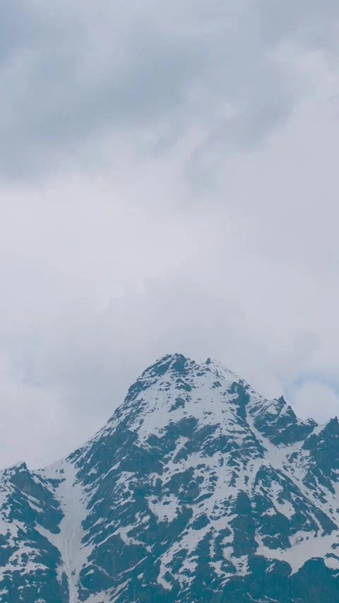 Vertical Time-lapse shot of clouds above the snow covered Himalayan mountain  Video stock 281066248