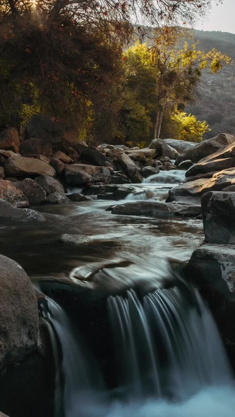 Vertical time lapse of a small rushing river as the sun rises Stock Footage 259455180