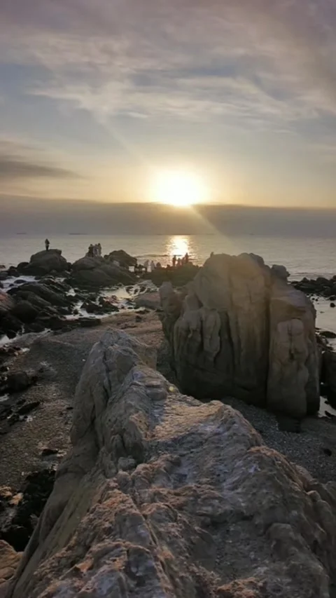Vertical Time Lapse Sunrise Over Rocky Coast with Silhouettes of People Watc Stock Footage 327105528